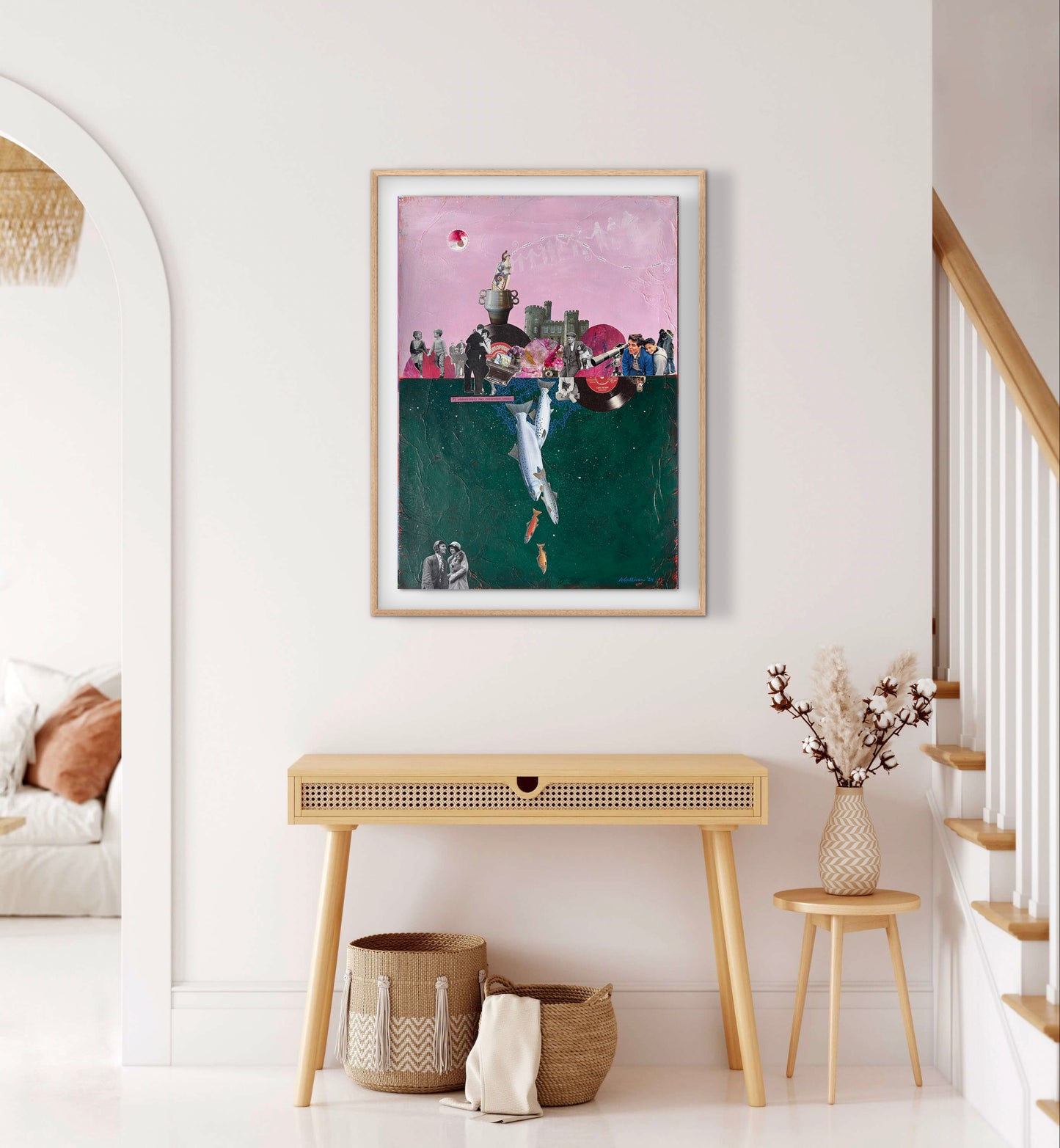 Framed artwork on a wall in a home interior with a console table and decorative items.