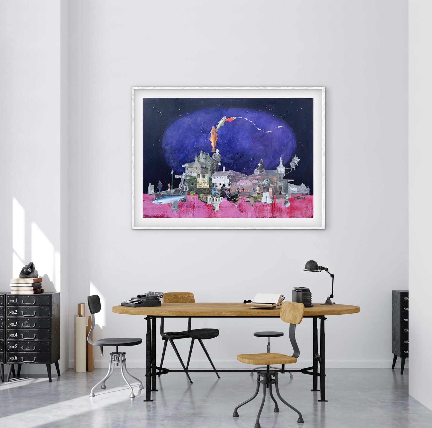 Framed artwork of a fantasy scene with a castle and moon in a modern office setting.