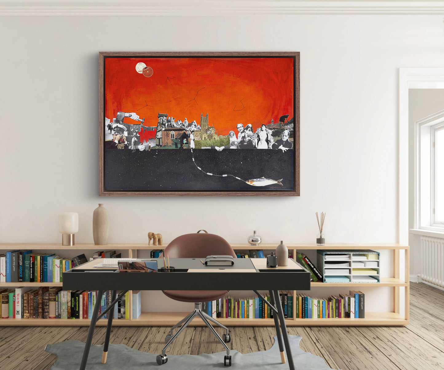 Framed artwork on a wall above a desk in a room with bookshelves.