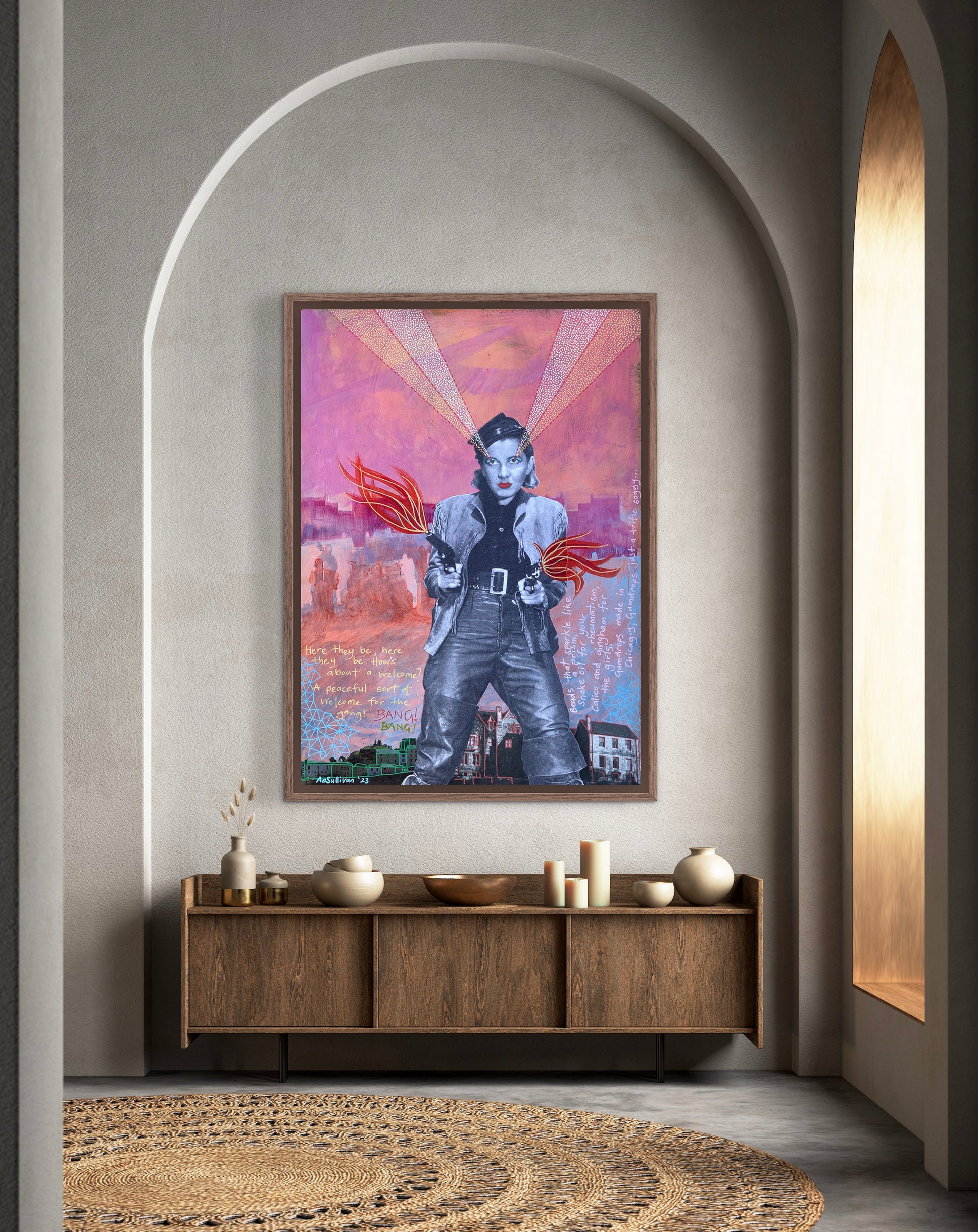 Framed artwork on a wall above a wooden console table with decorative items.