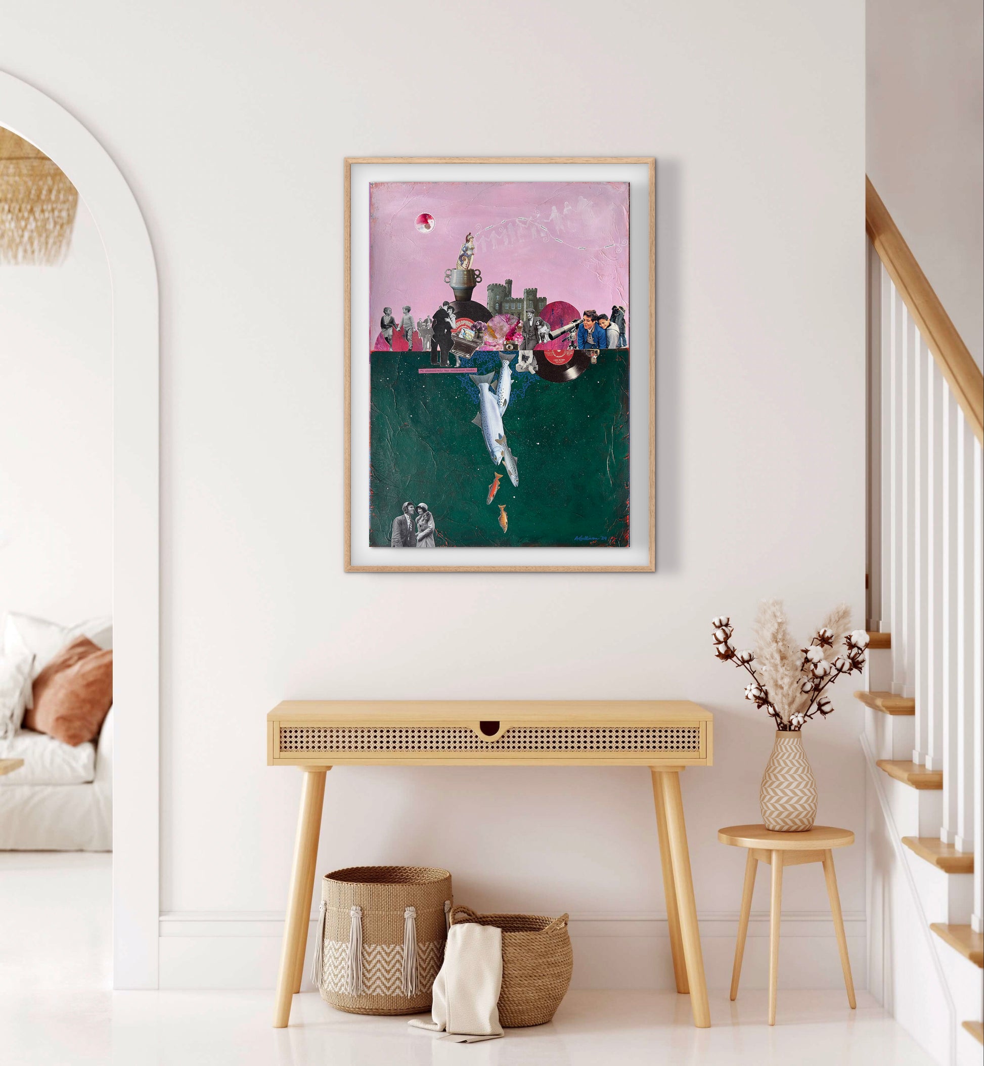 Framed artwork on a wall in a home interior with a console table and decorative items.