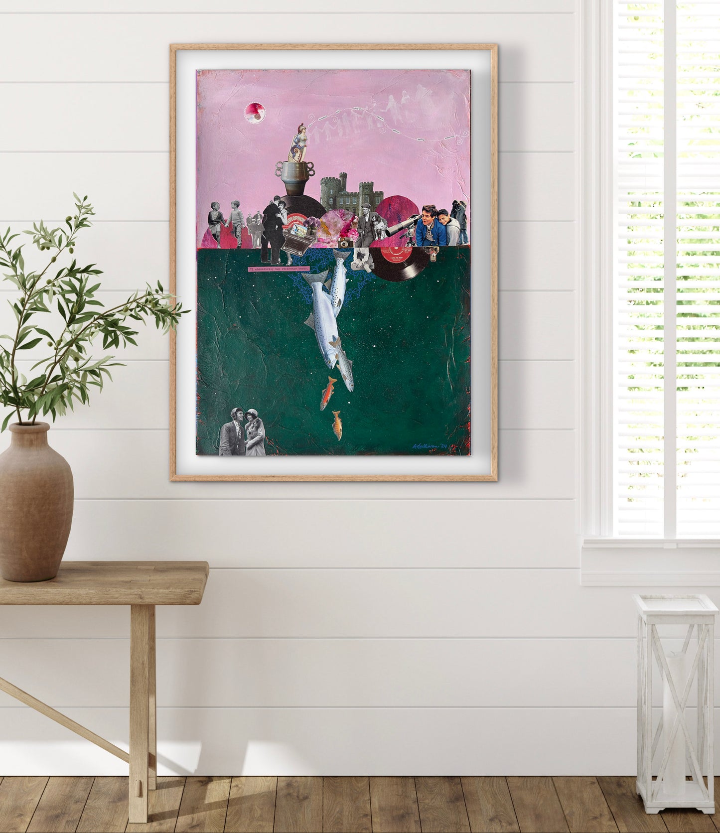 Framed artwork on a wall with a plant and table in the foreground