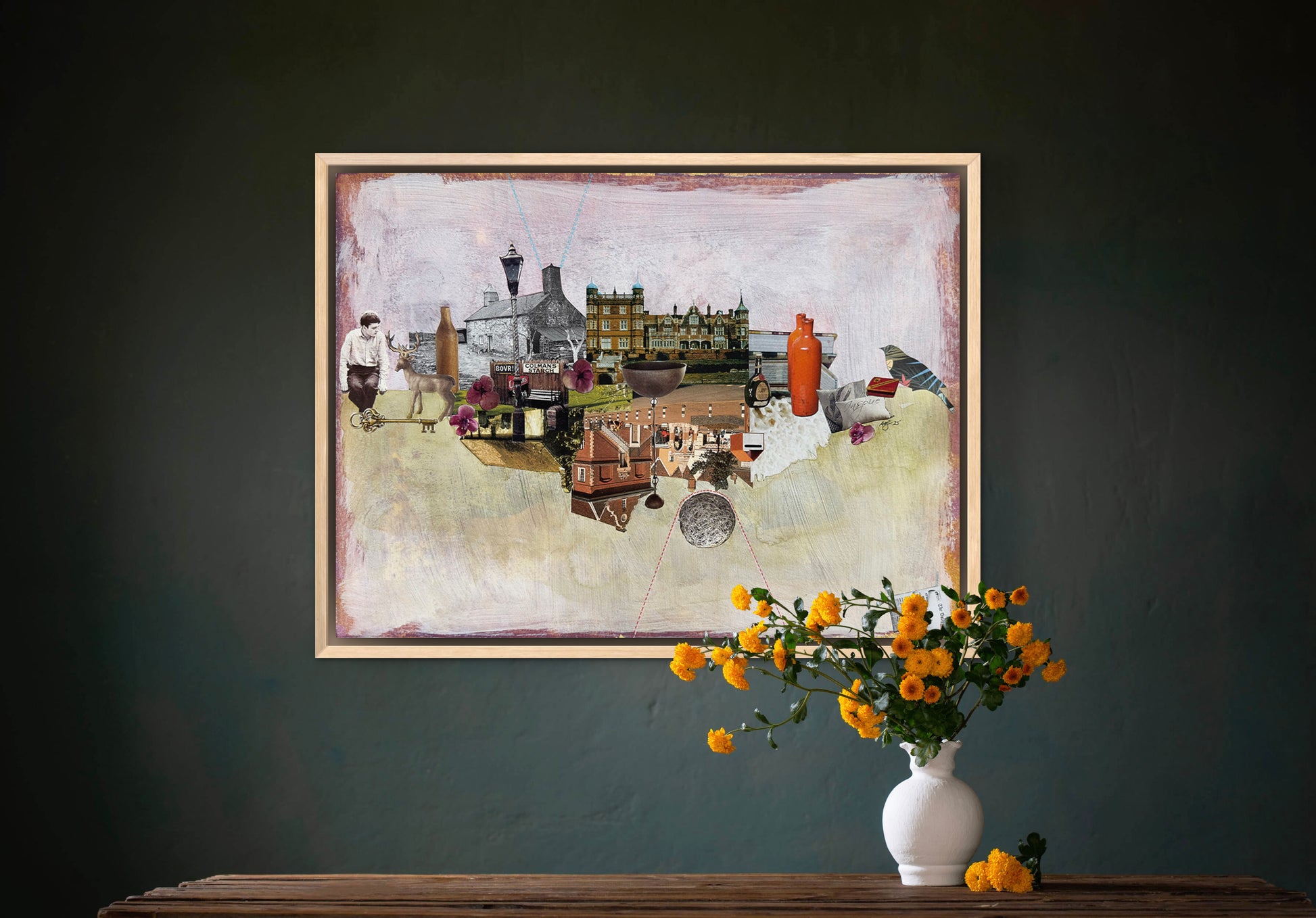 Framed artwork on a dark wall with a vase of flowers below