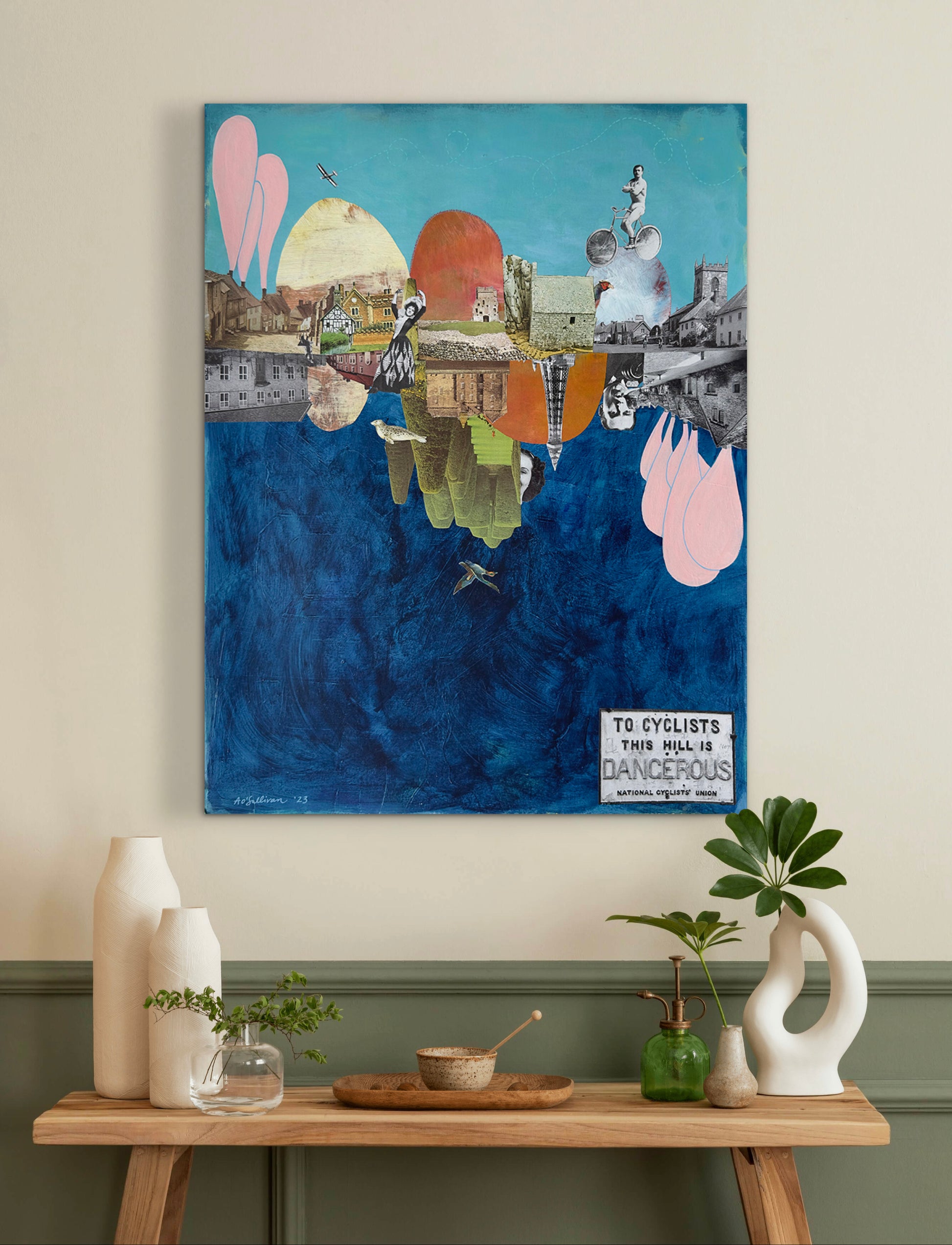 Colorful abstract painting on a wall above a wooden table with decorative items.