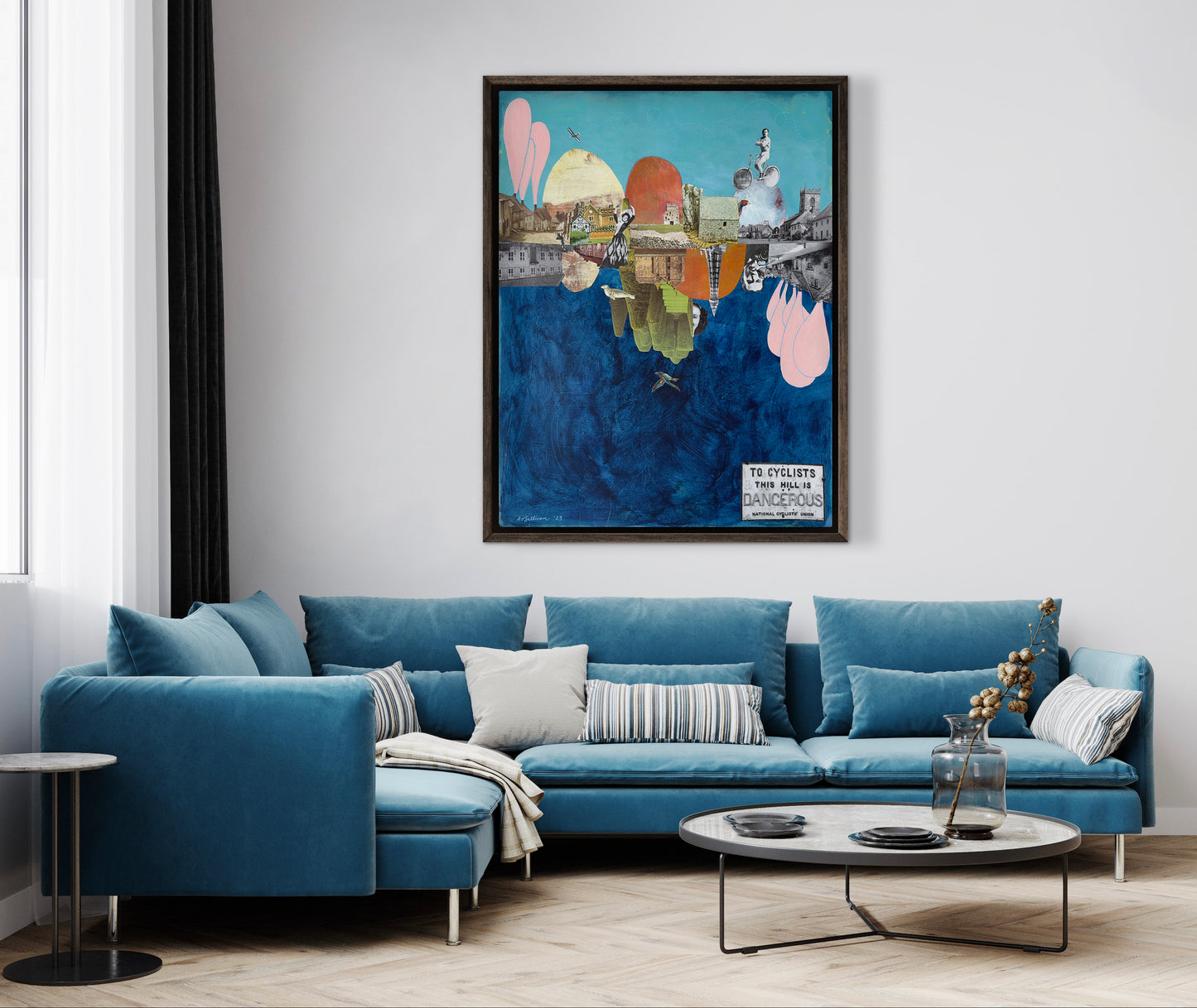Modern living room with a blue sectional sofa, round coffee table, and colorful abstract painting on the wall.