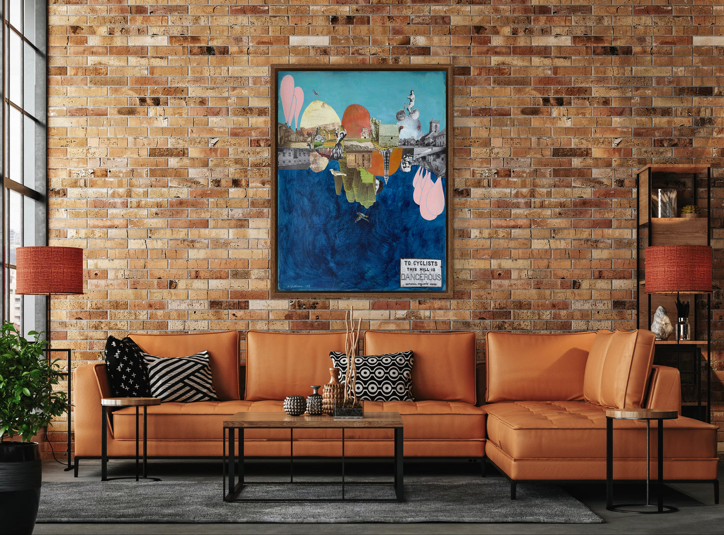 Living room with brown sectional sofa, coffee table, and decorative pillows against a brick wall.