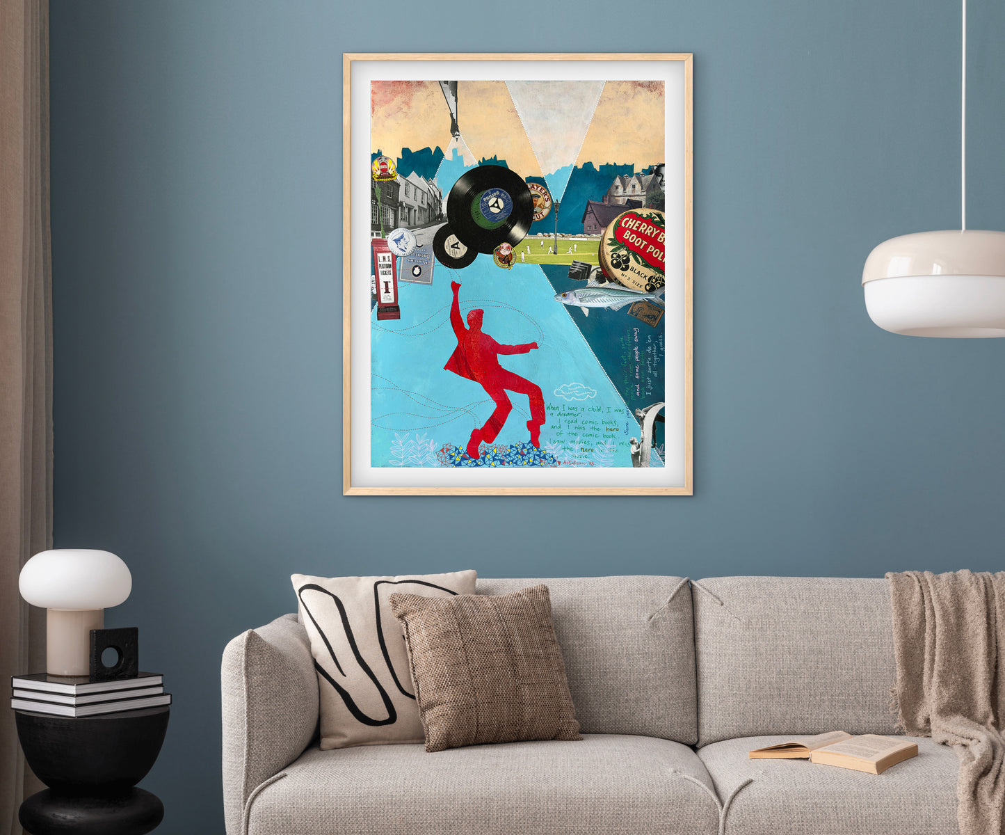 Framed collage art piece on a wall above a sofa in a living room.