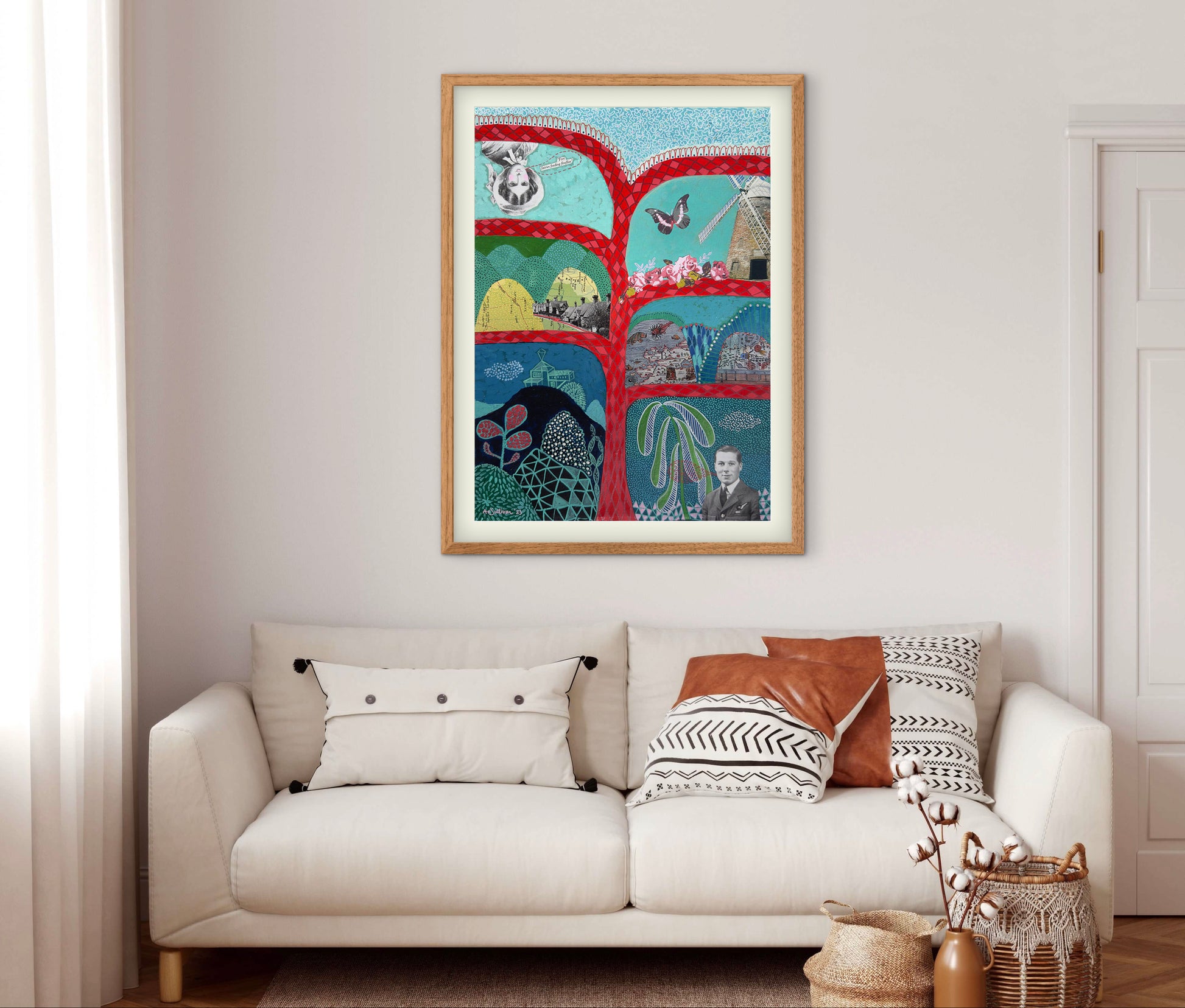 Framed artwork above a white sofa with decorative pillows in a living room.