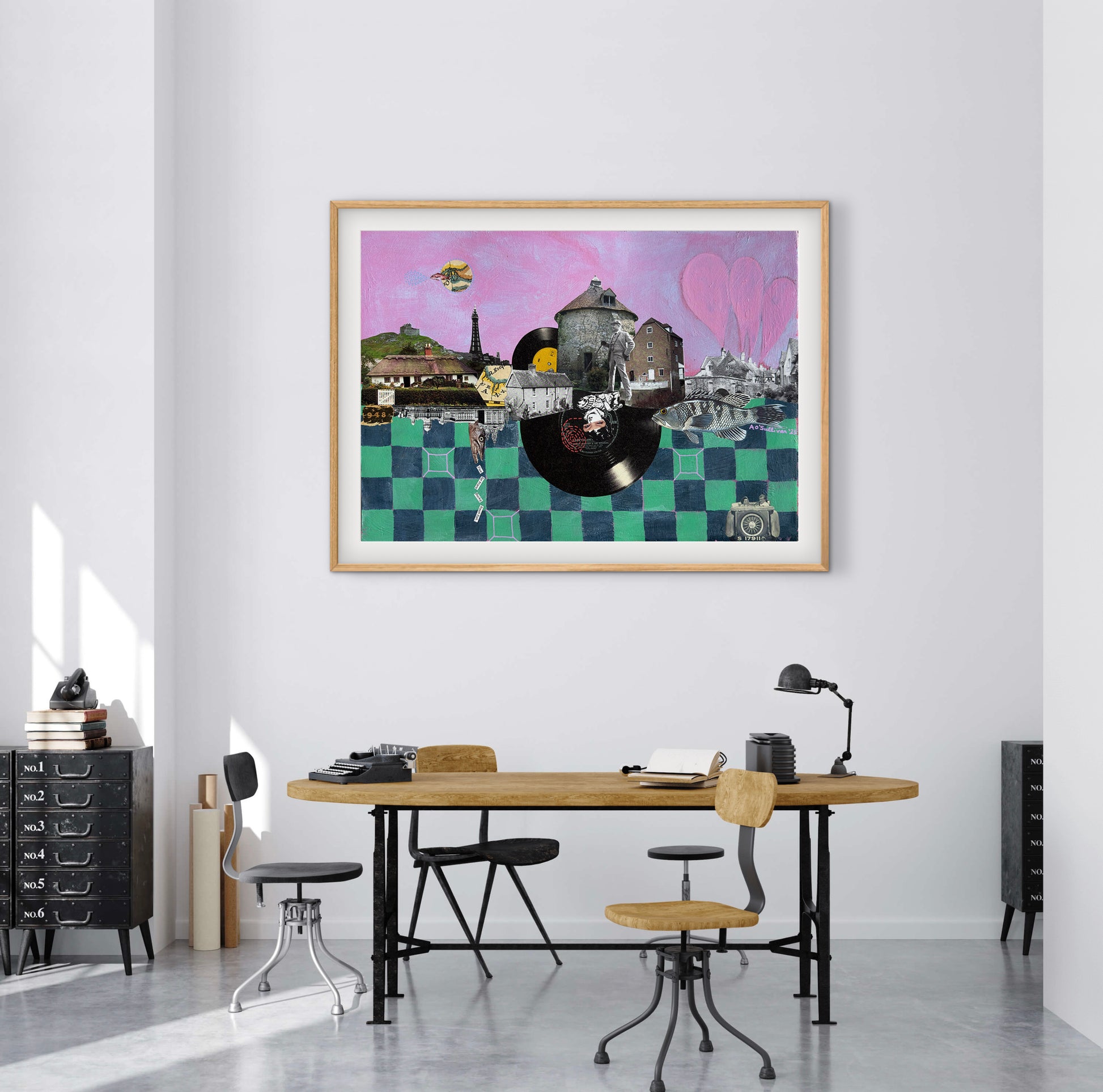 Colorful abstract art piece on a wall above a desk in a modern office setting.