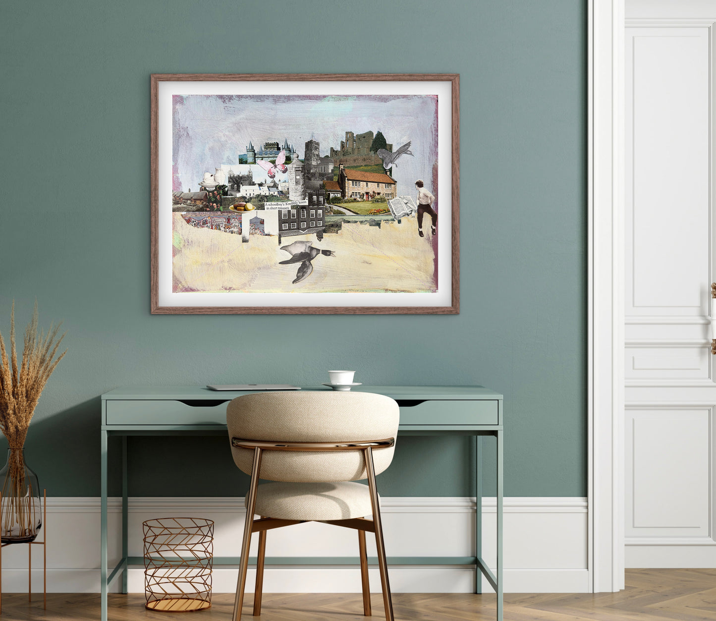 Framed artwork on a wall above a desk with a chair.