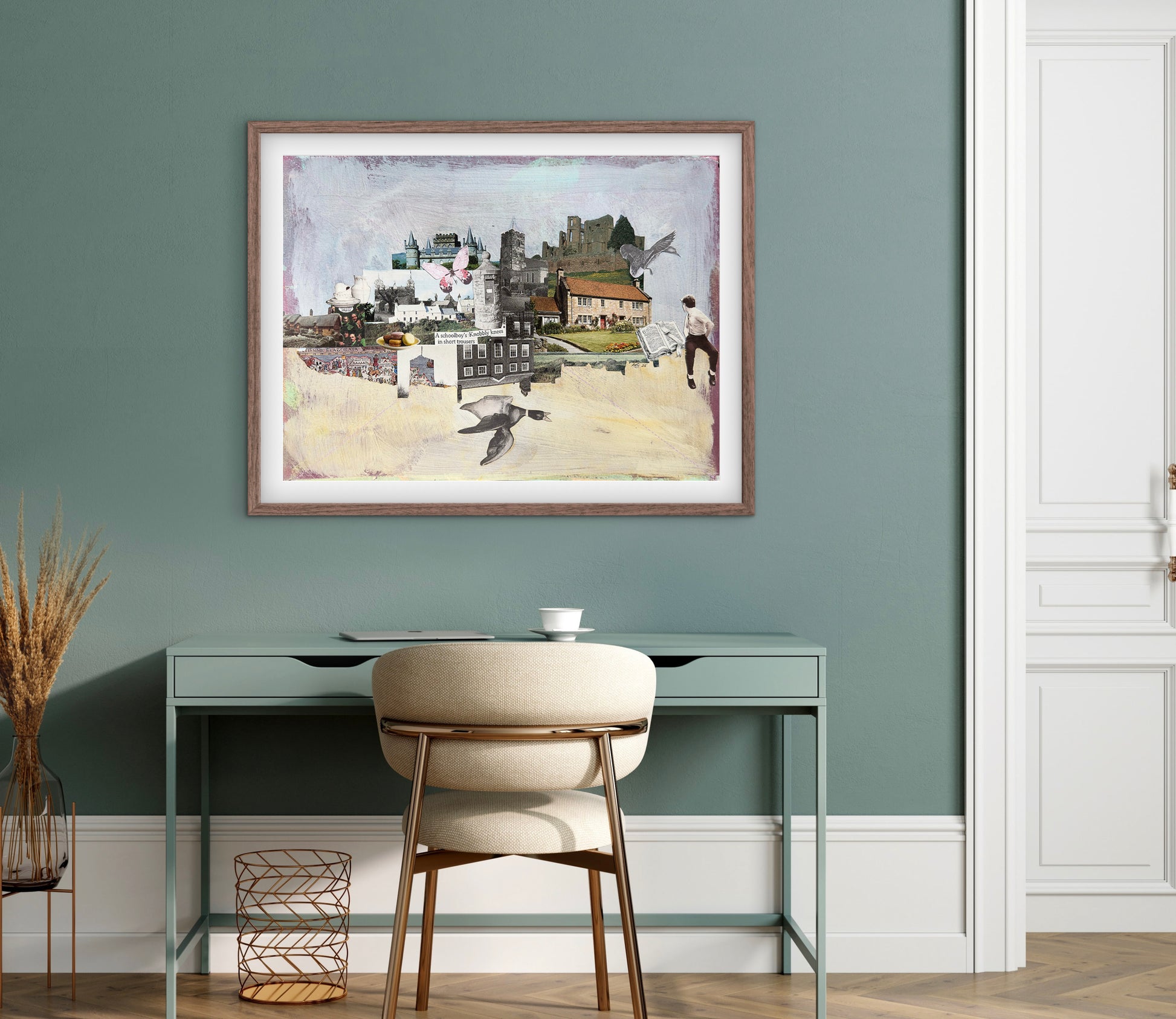 Framed artwork on a wall above a desk with a chair.