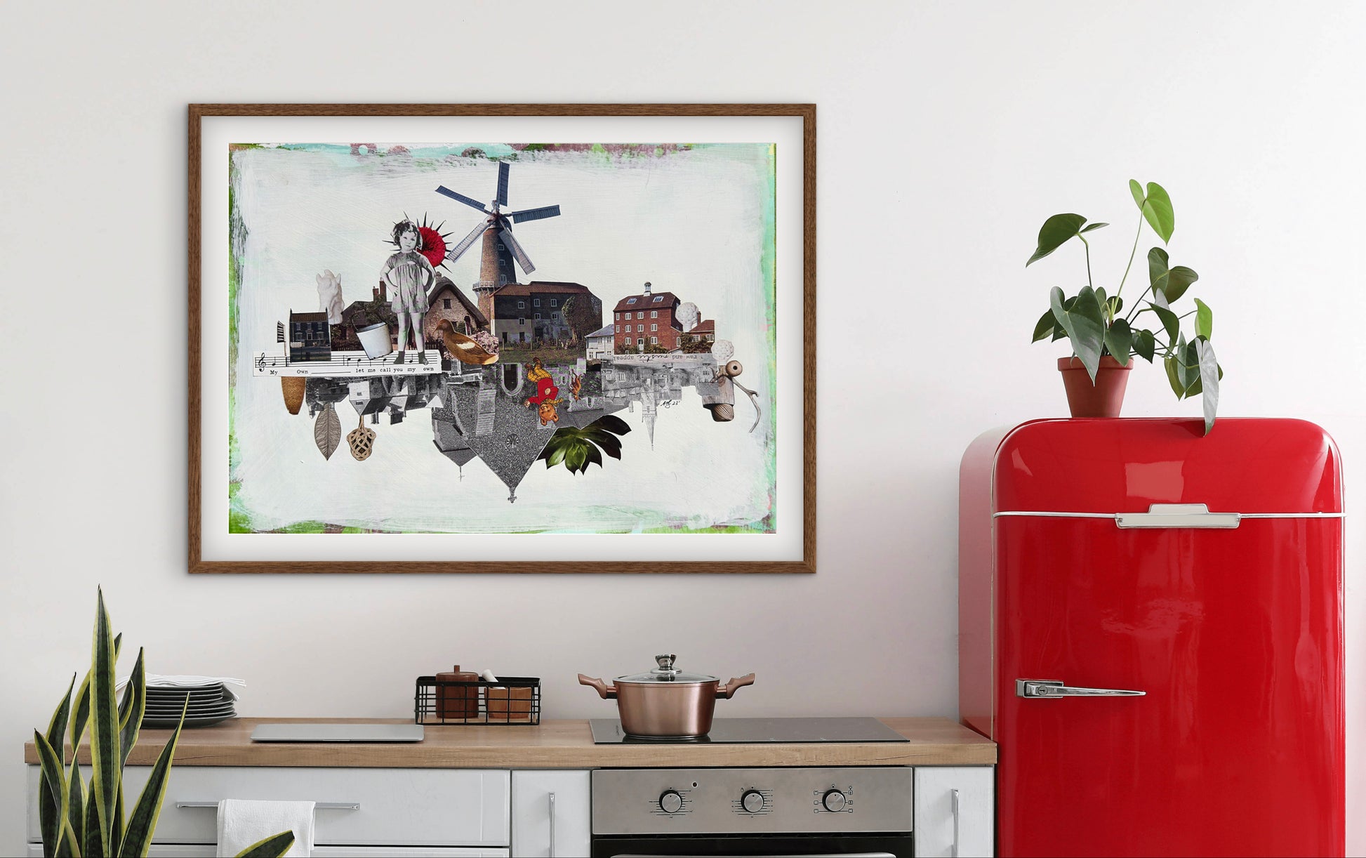 Red refrigerator next to a framed artwork in a kitchen setting