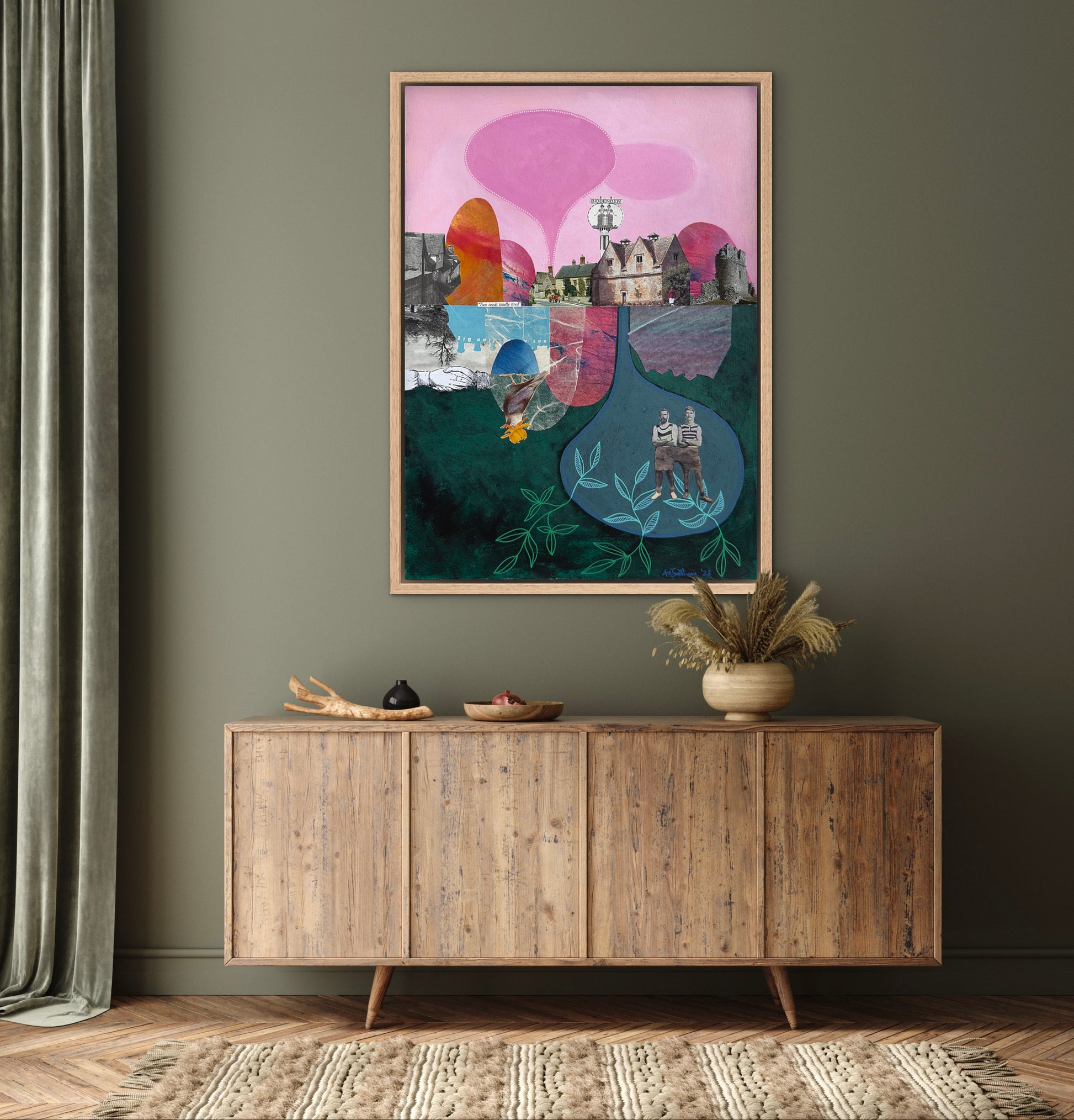 Framed abstract artwork on a wall above a wooden sideboard.