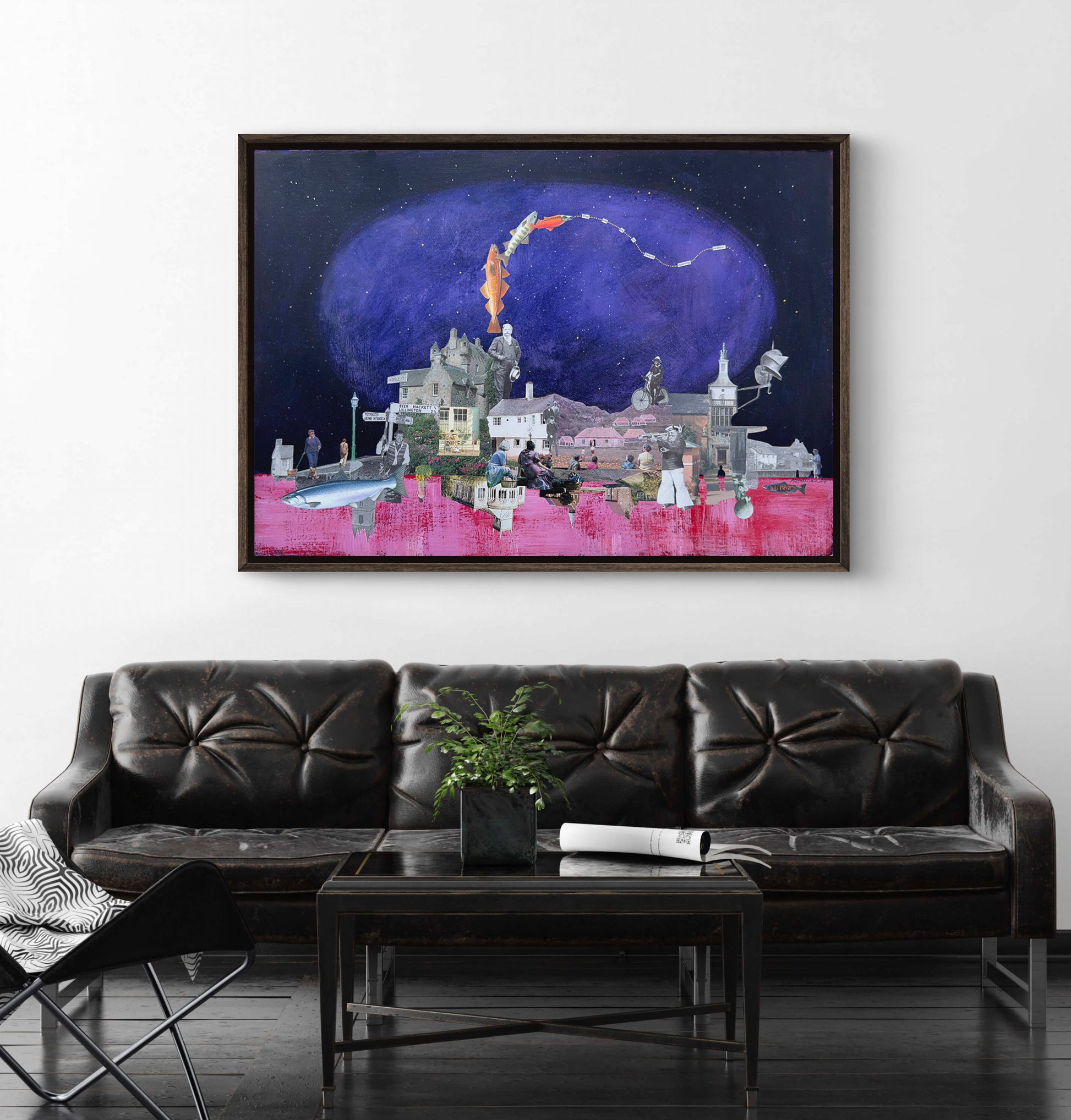 Framed artwork above a black leather sofa in a living room.