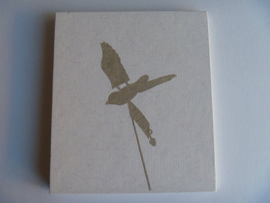 Silhouette of a bird on a textured beige card