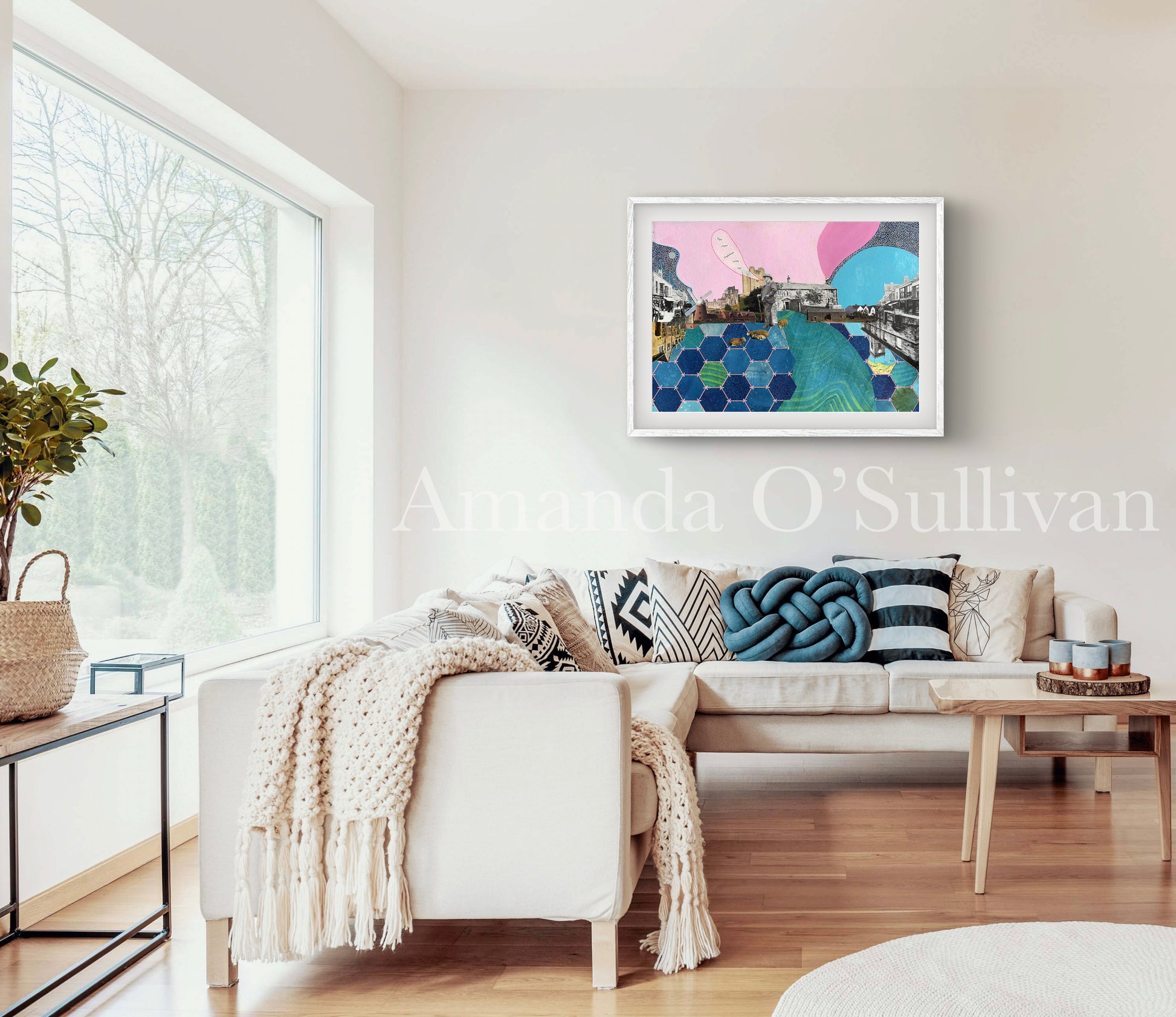 Modern living room with a white sofa, colorful artwork on the wall, and natural light.